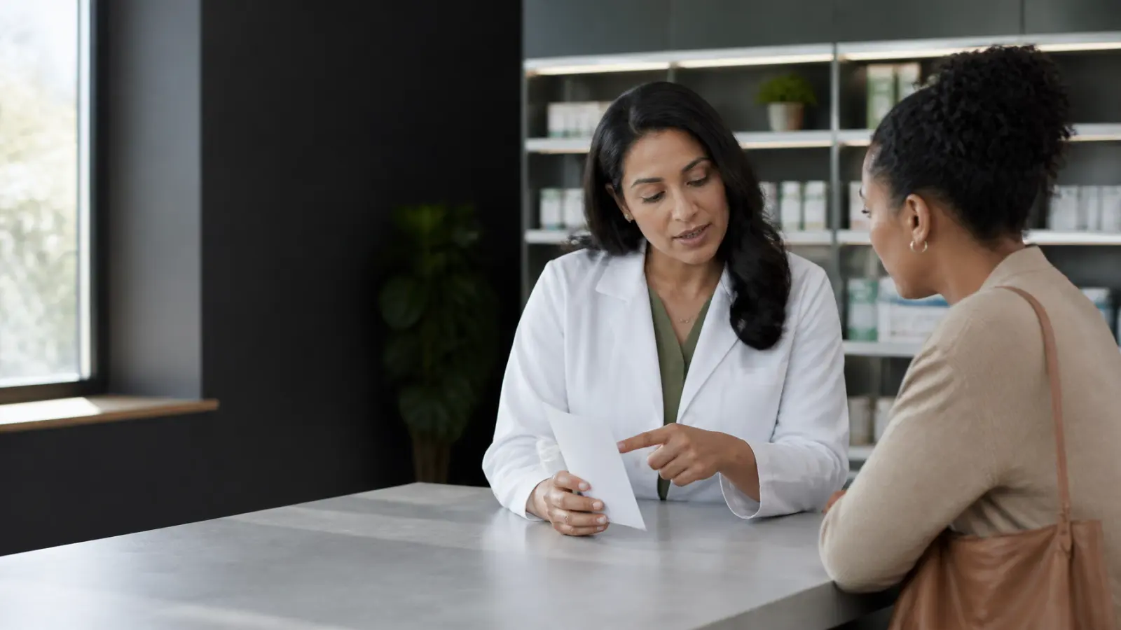 Pharmacist explaining medication information to an engaged patient at a contemporary pharmacy counter